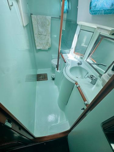 Bathroom interior of 1996 Beneteau Oceanis 40 CC yacht, featuring sink and shower.