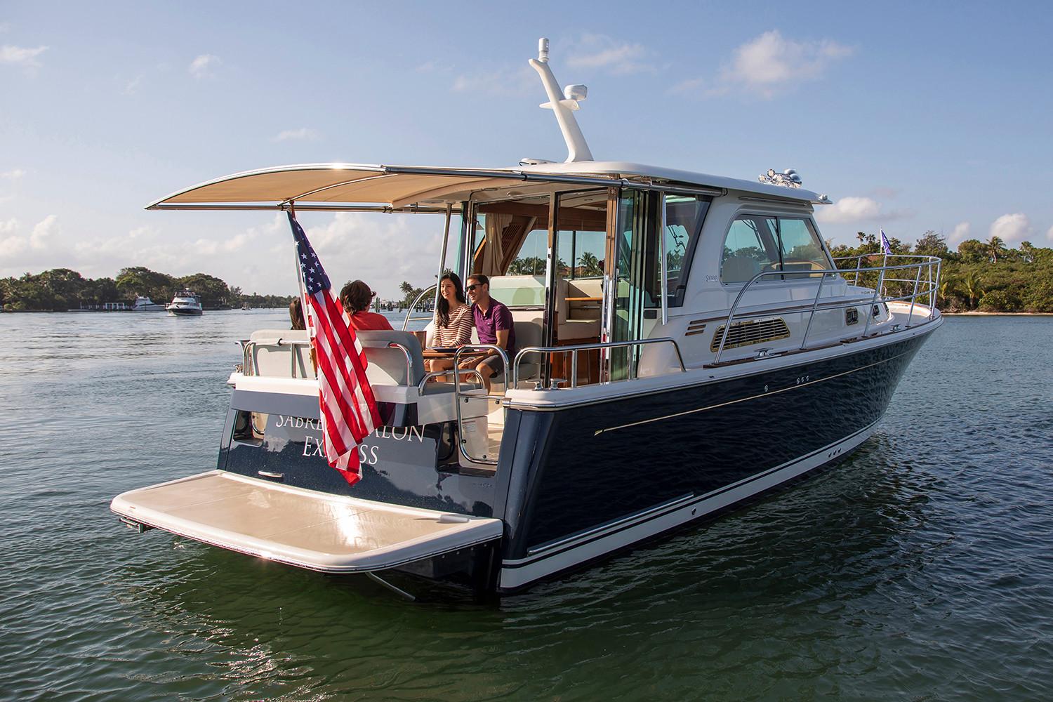 Manufacturer Provided Image: 2026 Sabre 38 Salon Express yacht cruising on a sunny day with passengers onboard.
