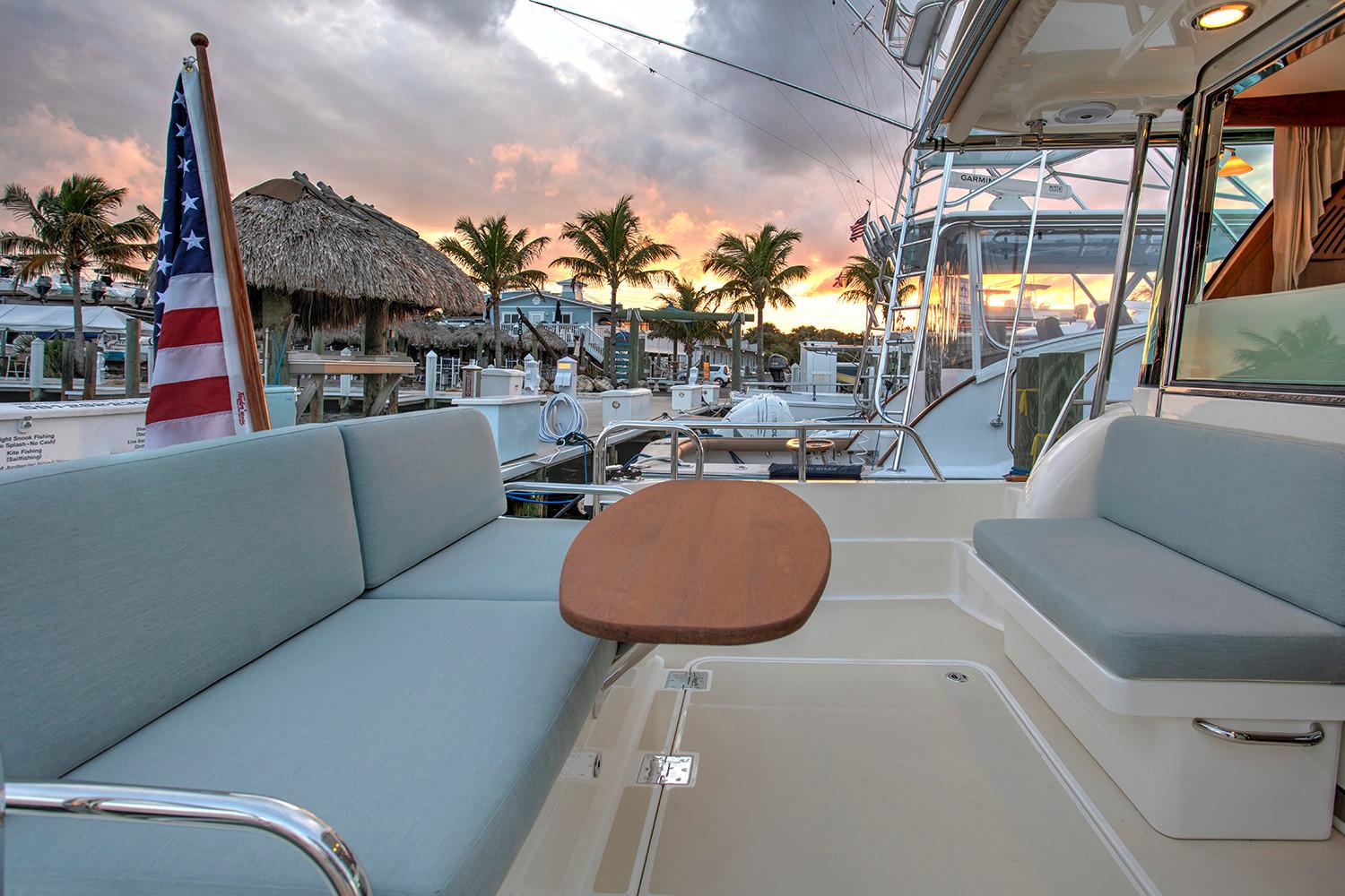 Manufacturer Provided Image: 2026 Sabre 38 Salon Express yacht with sunset view, featuring comfortable seating and elegant design.