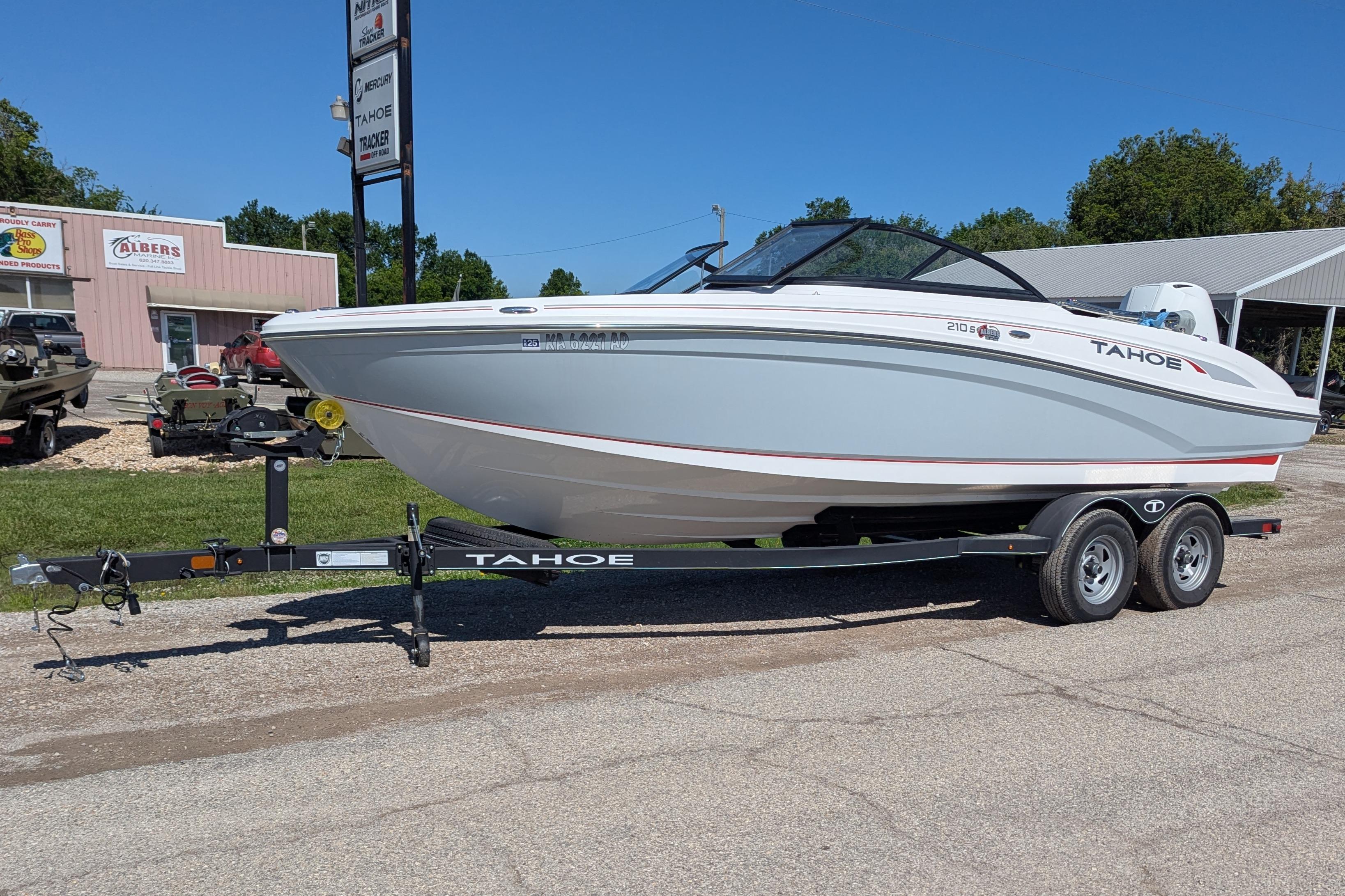 2022 Tahoe 210 S boat on trailer, parked outdoors near buildings.