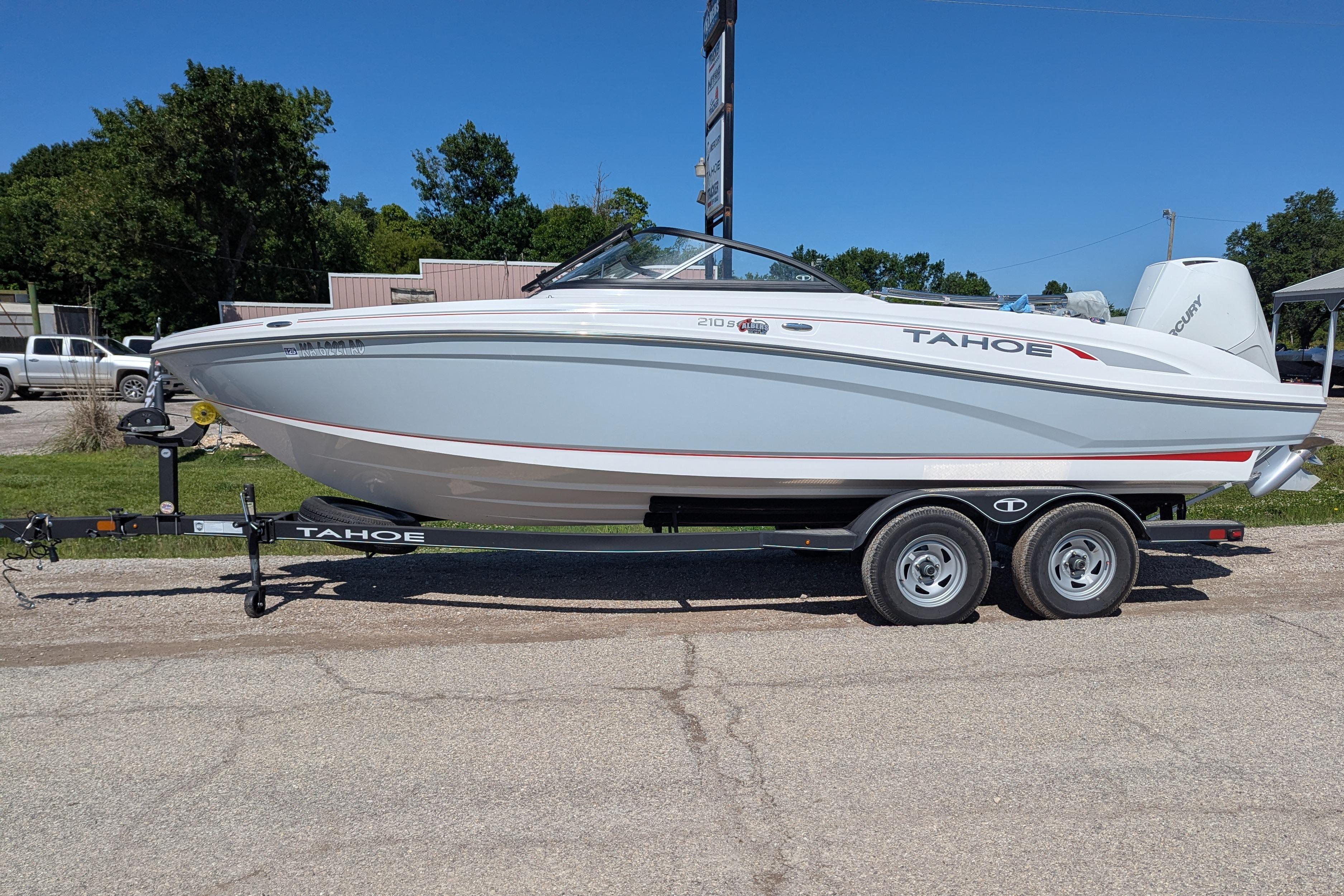2022 Tahoe 210 S boat on trailer, parked outdoors on a sunny day.