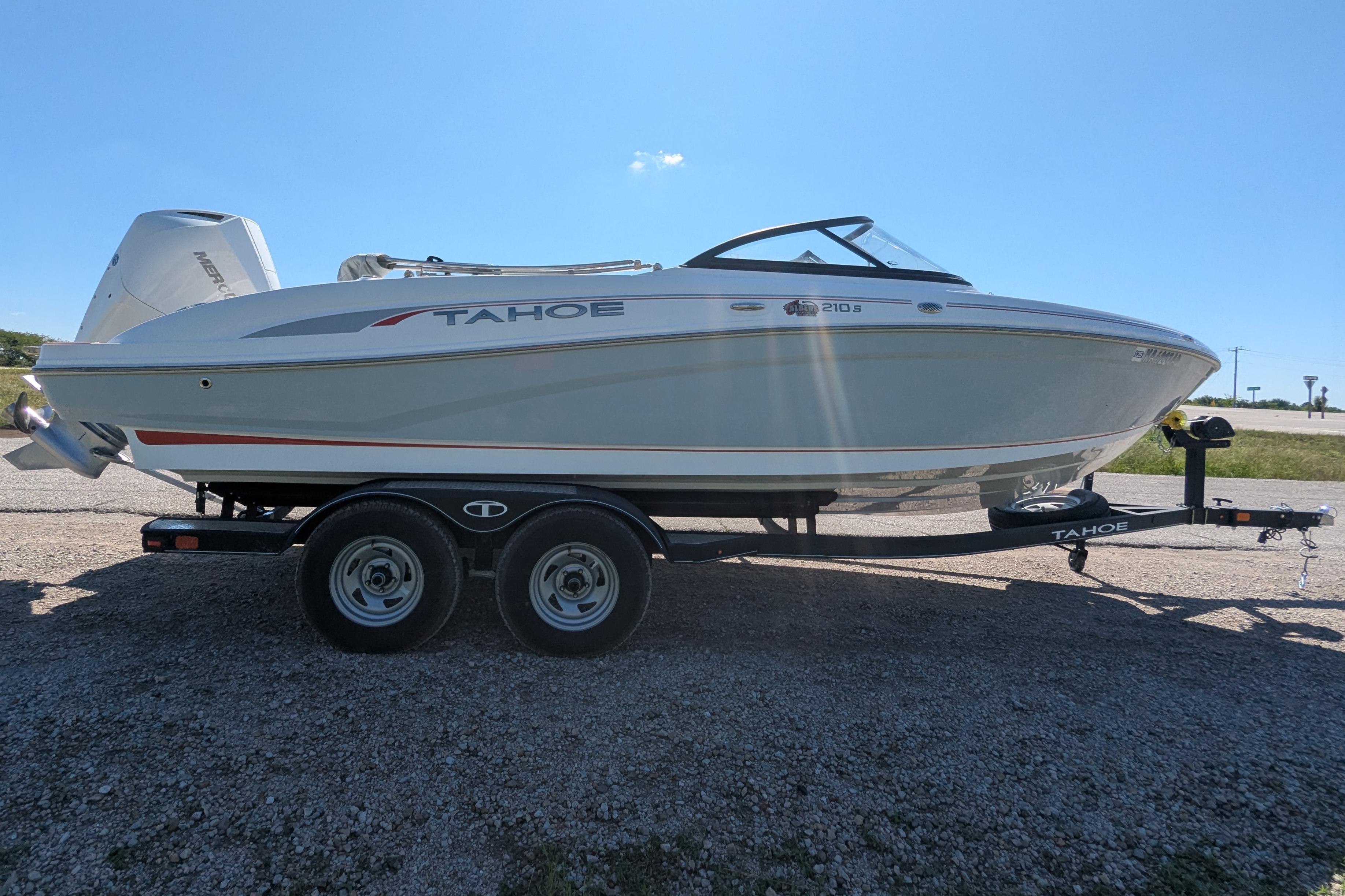 2022 Tahoe 210 S boat on trailer under clear blue sky.