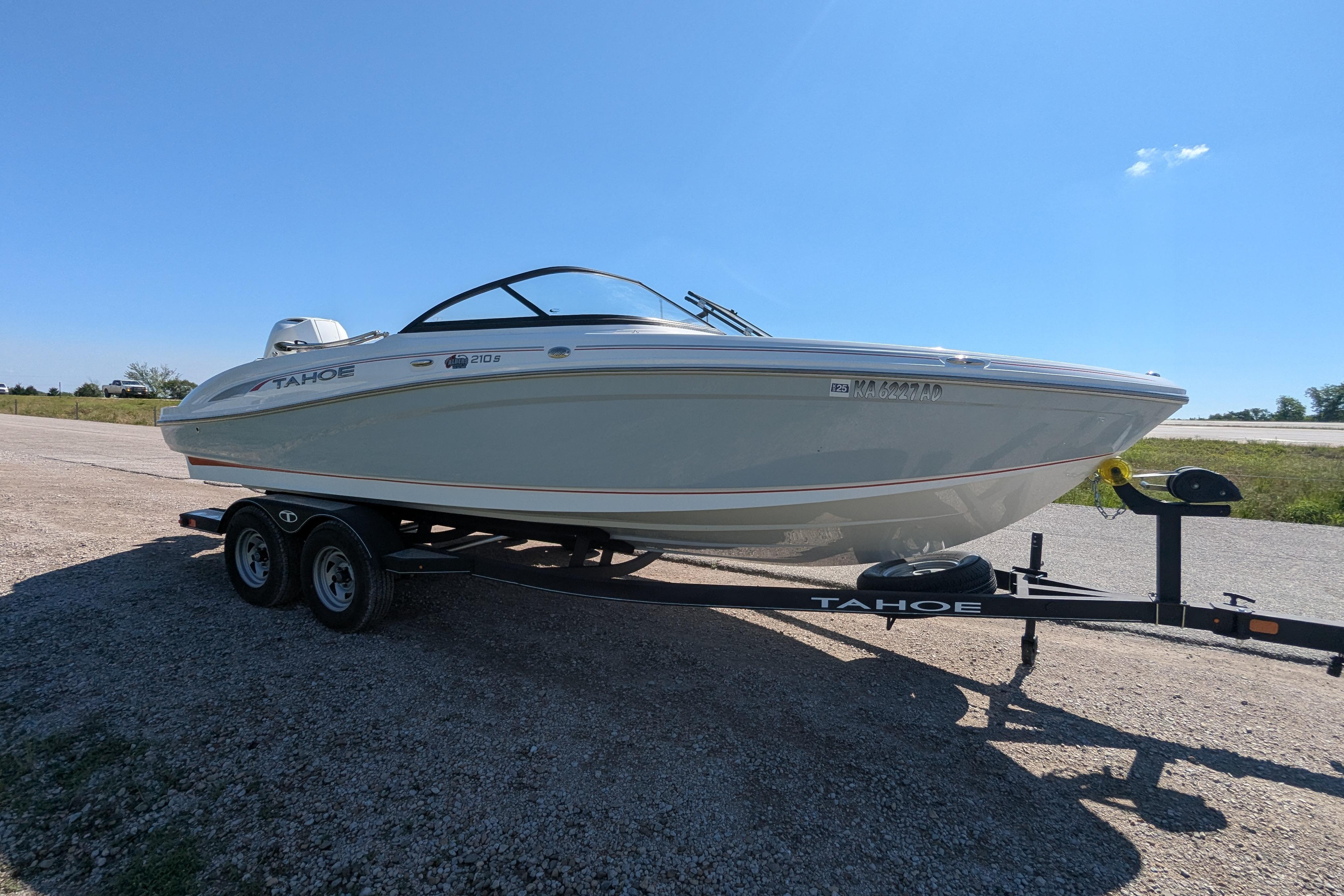 2022 Tahoe 210 S boat on trailer under clear blue sky.