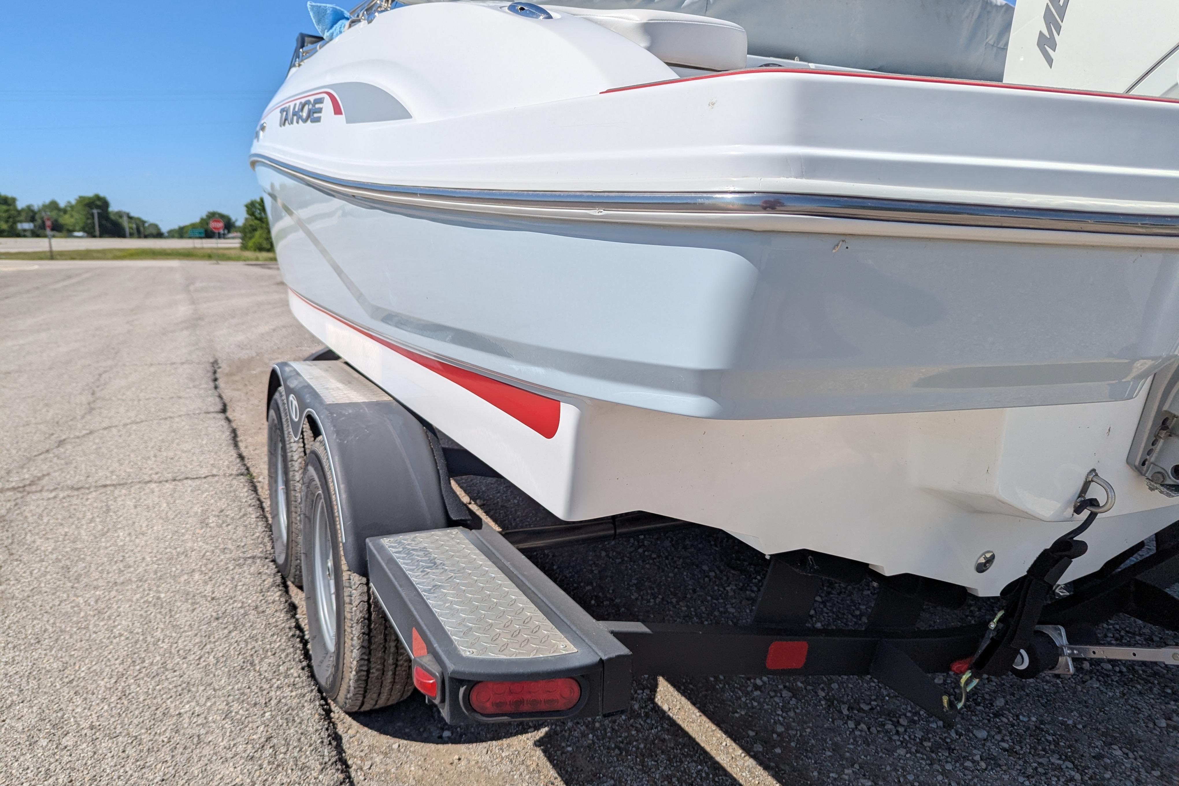 2022 Tahoe 210 S boat on trailer, parked on sunny day.