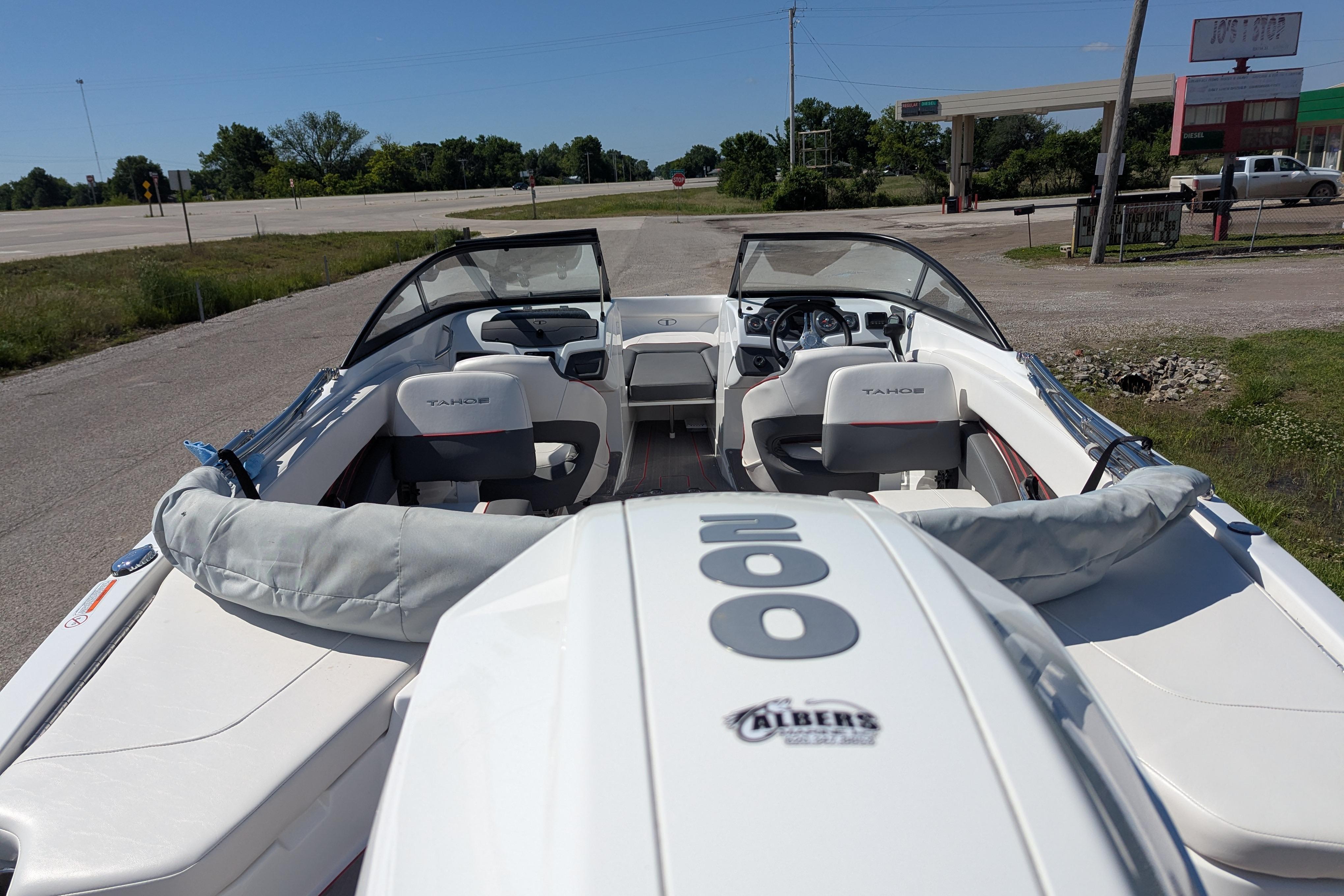 2022 Tahoe 210 S boat interior with seating and dashboard, parked on a sunny day.