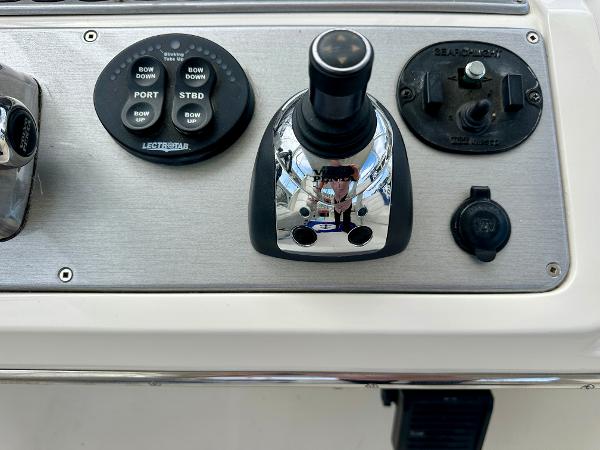 Control panel of a 2008 Carver 43 Super Sport boat with joystick and buttons.