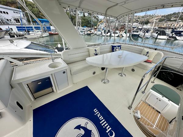 2008 Carver 43 Super Sport yacht with spacious seating and marina view.