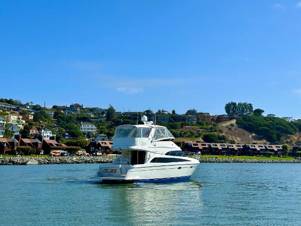 2008 Carver 43 Super Sport yacht cruising on a scenic waterway.