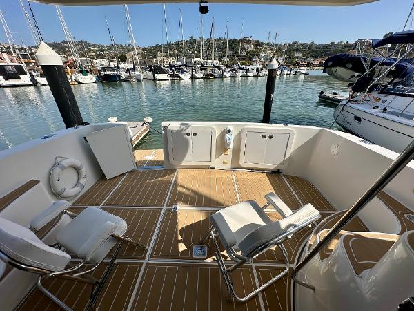 2008 Carver 43 Super Sport yacht deck with chairs, docked at marina.