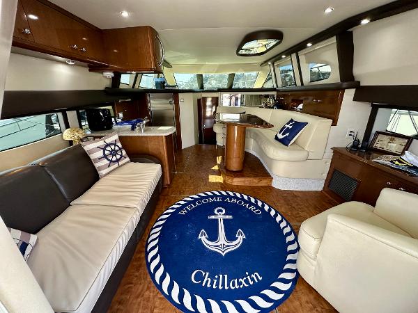 Luxurious interior of 2008 Carver 43 Super Sport yacht with nautical decor and plush seating.