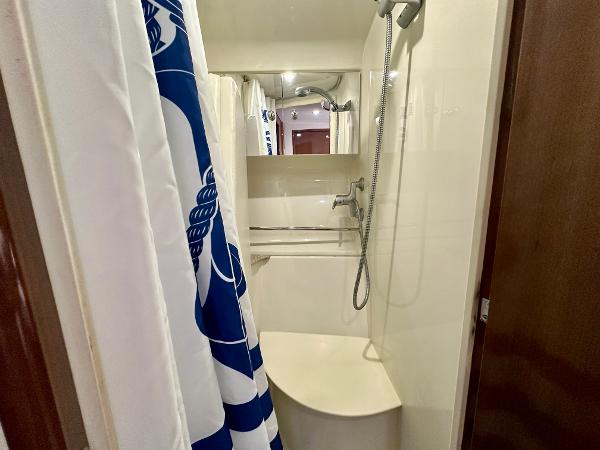 Shower area in 2008 Carver 43 Super Sport yacht with blue and white curtain.