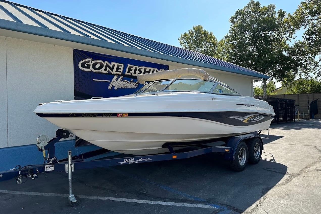 2002 Rinker 212 Captiva boat on trailer at Gone Fishin' Marine dealership.