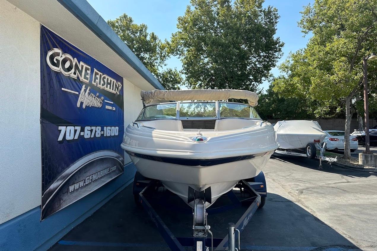 2002 Rinker 212 Captiva boat on trailer at Gone Fishin' Marine dealership.
