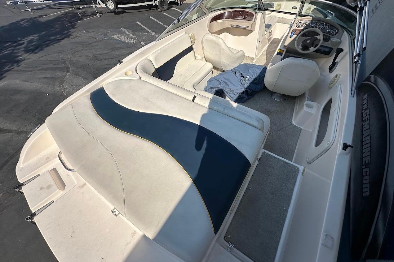 2002 Rinker 212 Captiva boat interior with seating and steering wheel.