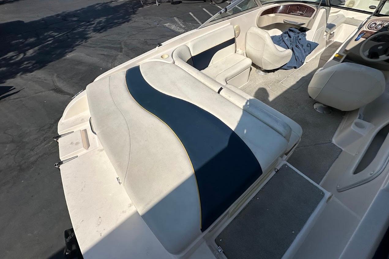 2002 Rinker 212 Captiva boat interior with seating and dashboard view.