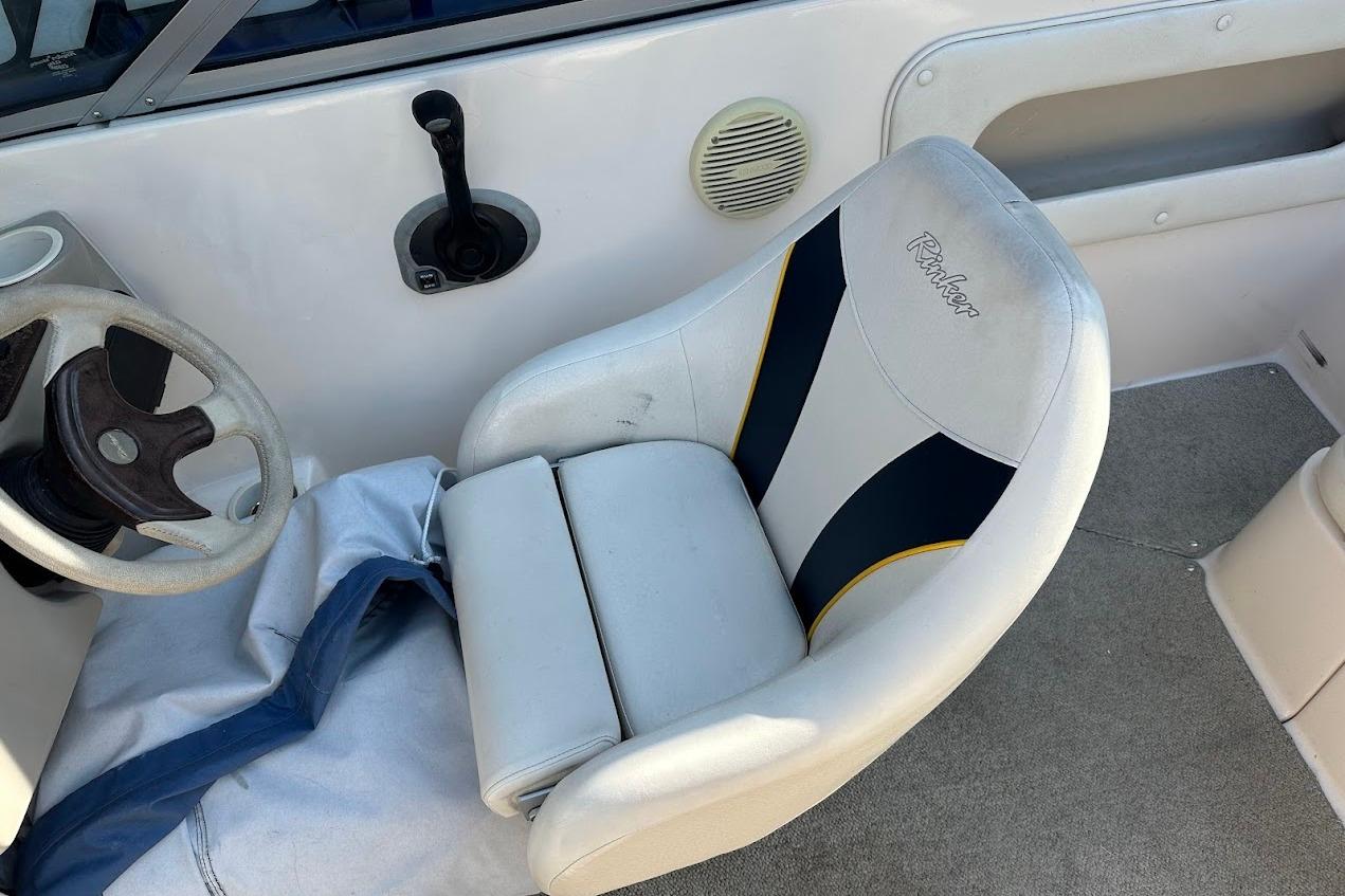 2002 Rinker 212 Captiva boat interior with steering wheel and captain's seat.