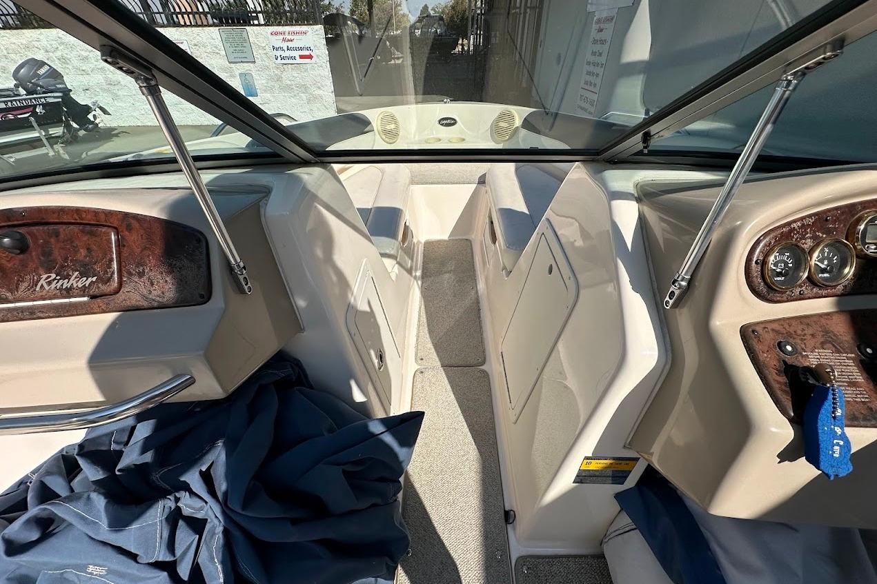 2002 Rinker 212 Captiva boat interior with dashboard and seating area.