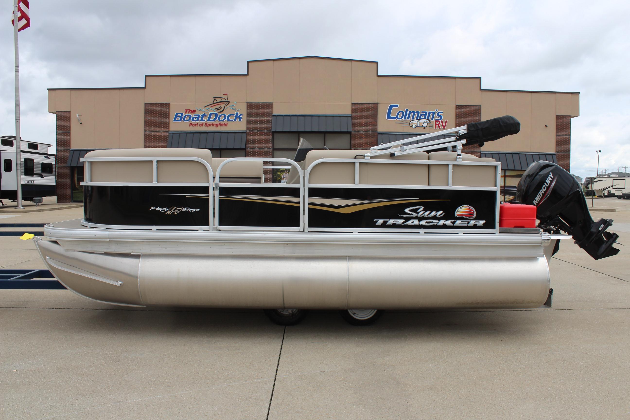 2025 Sun Tracker Party Barge 16 DLX pontoon boat parked outside dealership.