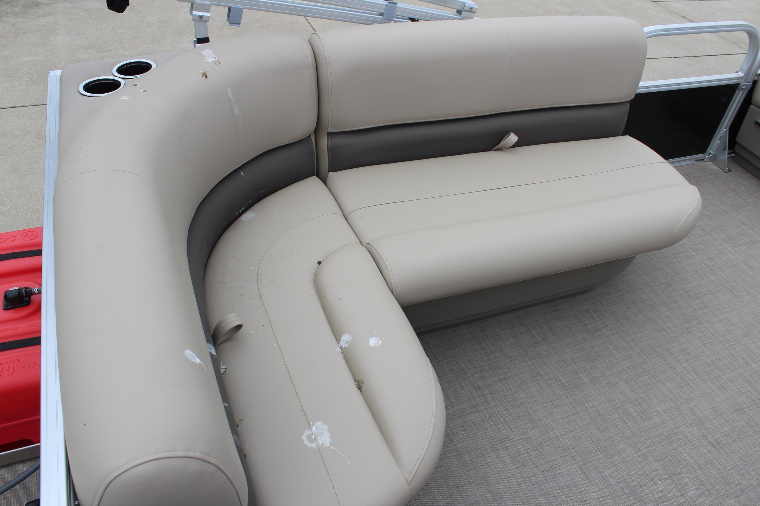 2025 Sun Tracker Party Barge 16 DLX pontoon boat seating area with beige upholstery.