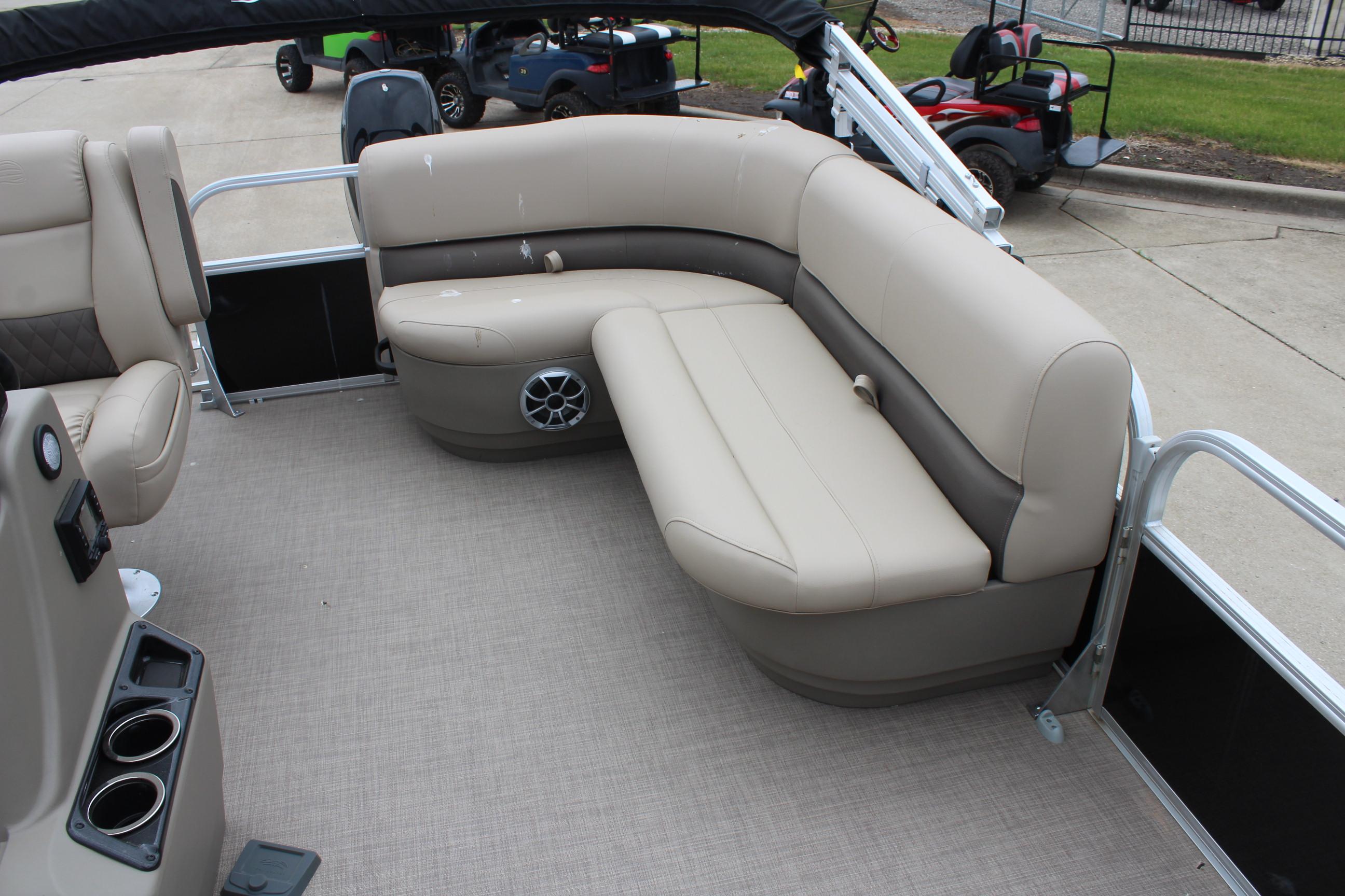 2025 Sun Tracker Party Barge 16 DLX with beige seating and cup holders.