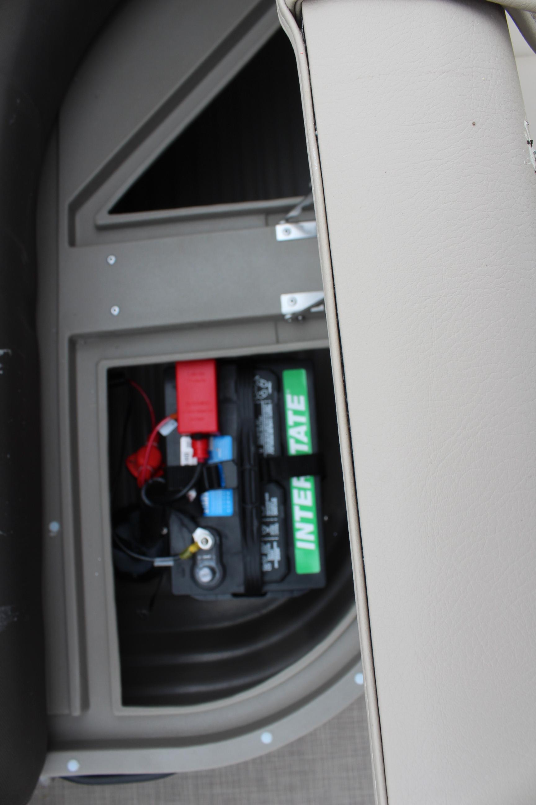 2025 Sun Tracker Party Barge 16 DLX battery compartment with visible wiring and components.