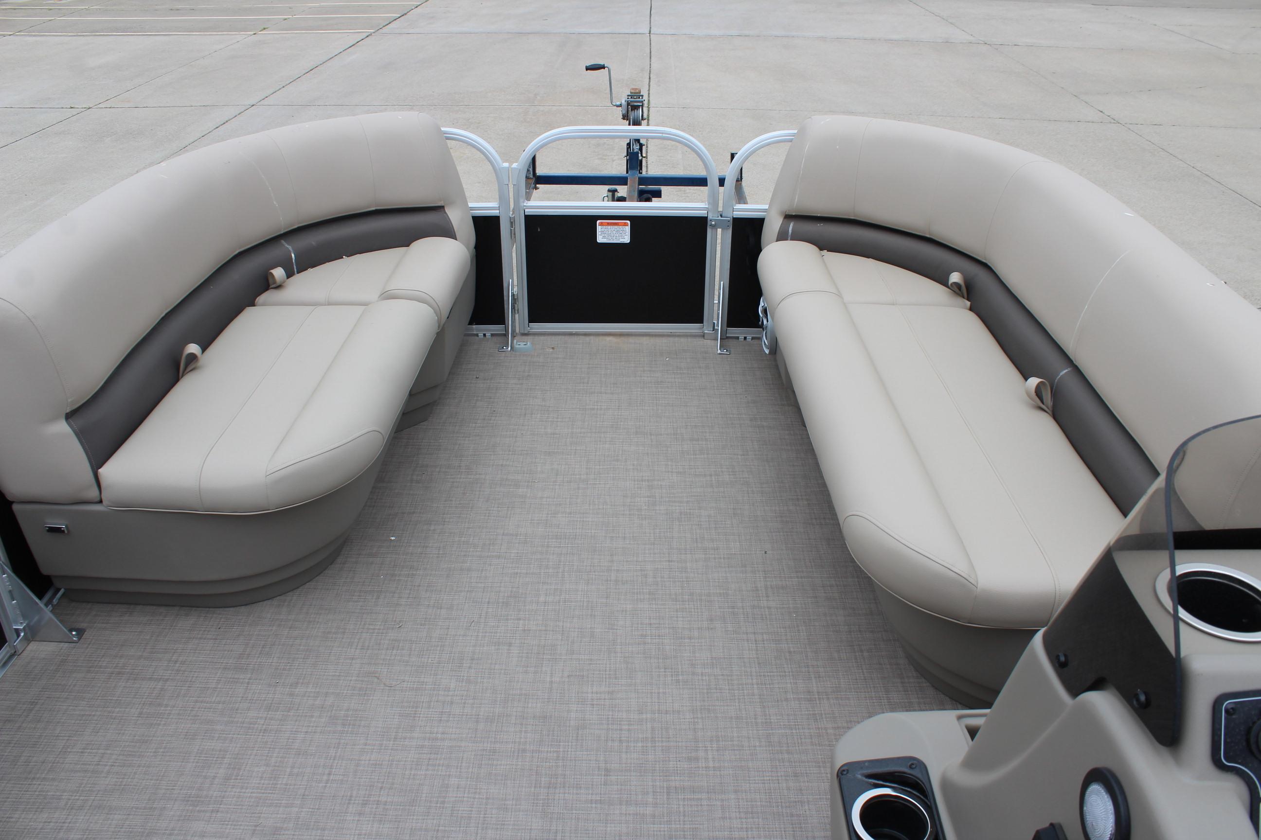 2025 Sun Tracker Party Barge 16 DLX interior with beige seating and cup holders.