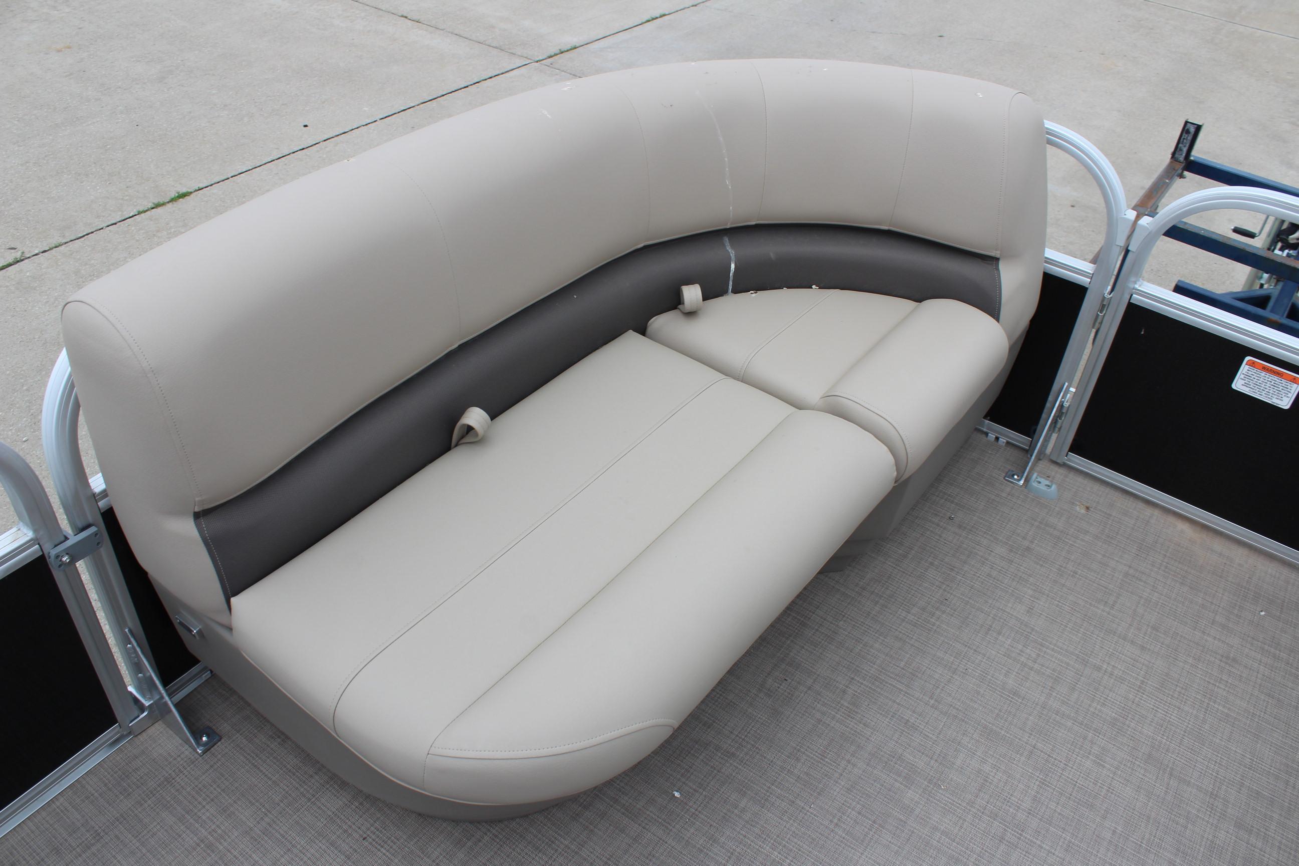 2025 Sun Tracker Party Barge 16 DLX pontoon boat seating, beige upholstery, outdoor setting.