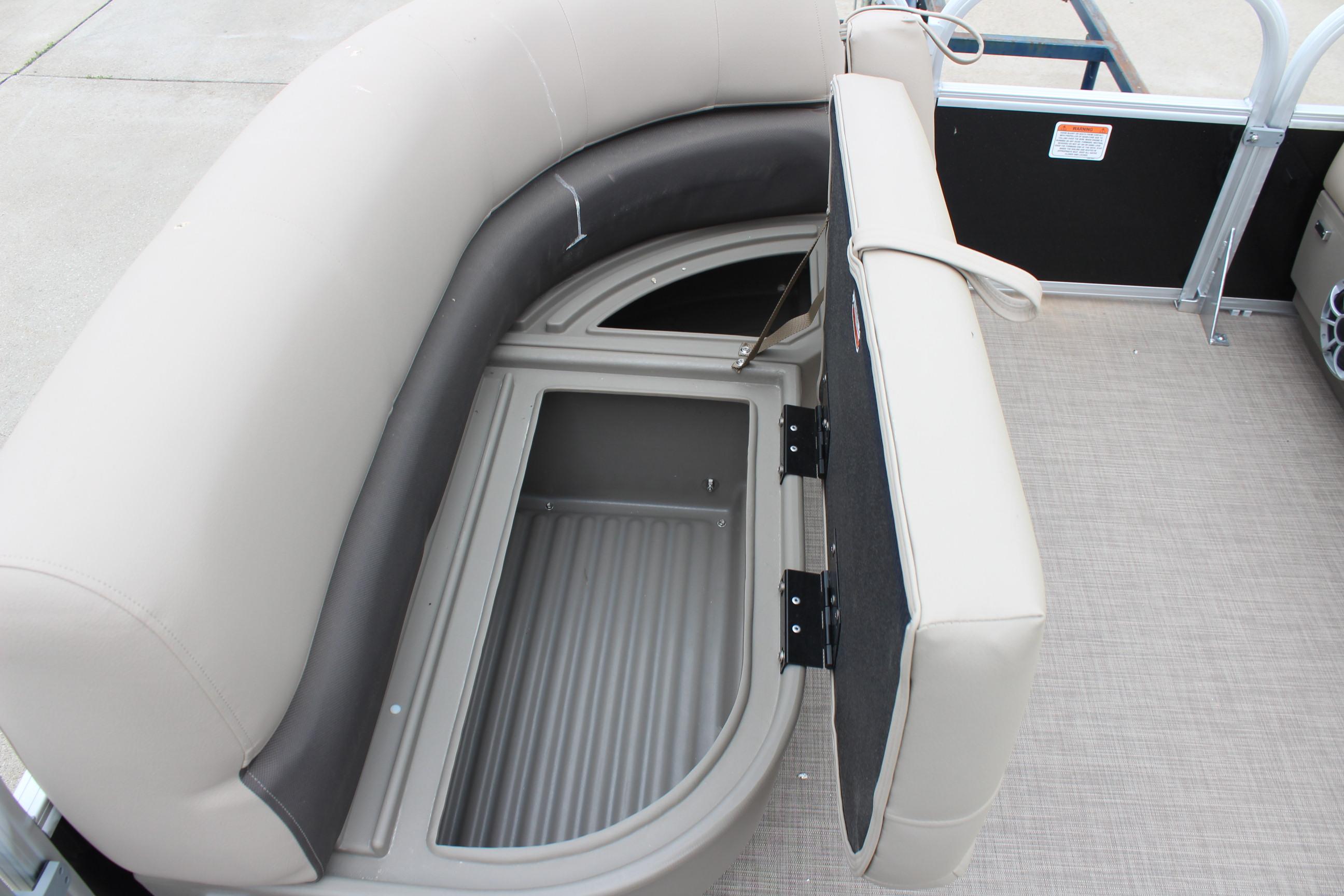 2025 Sun Tracker Party Barge 16 DLX seating with storage compartment open.