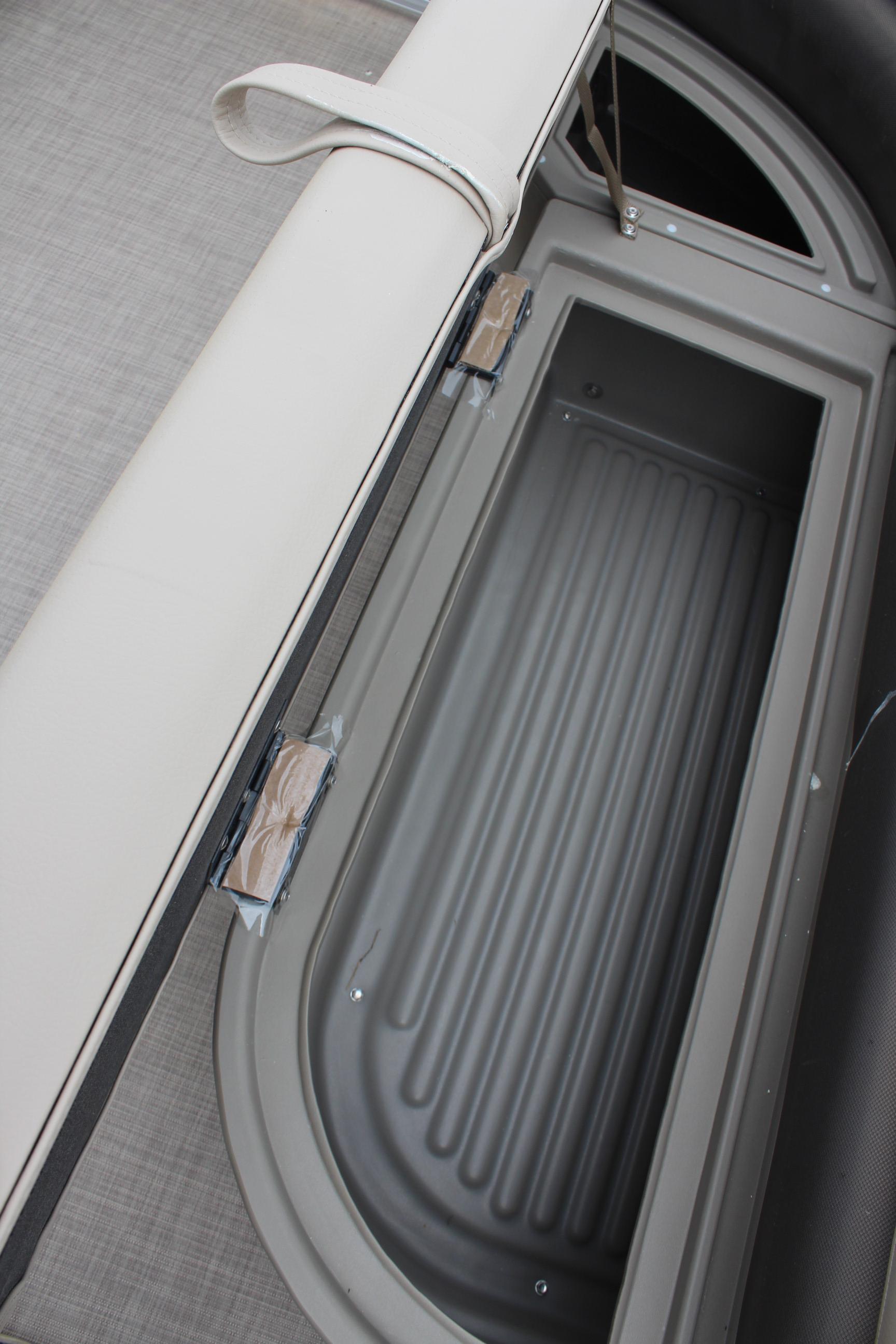 2025 Sun Tracker Party Barge 16 DLX storage compartment with cushioned seating.