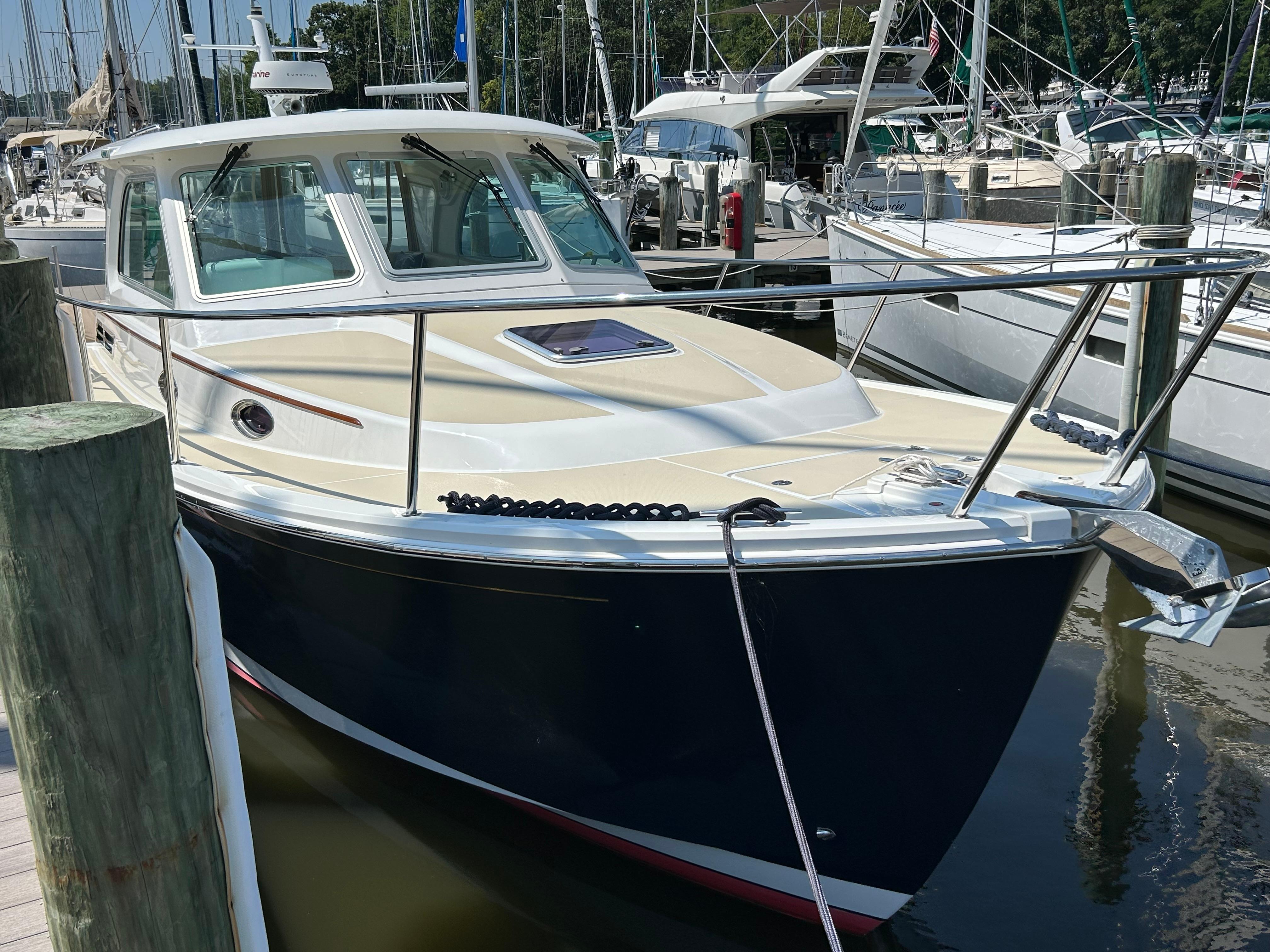 2018 Back Cove 32 boat docked at a marina, surrounded by other vessels.