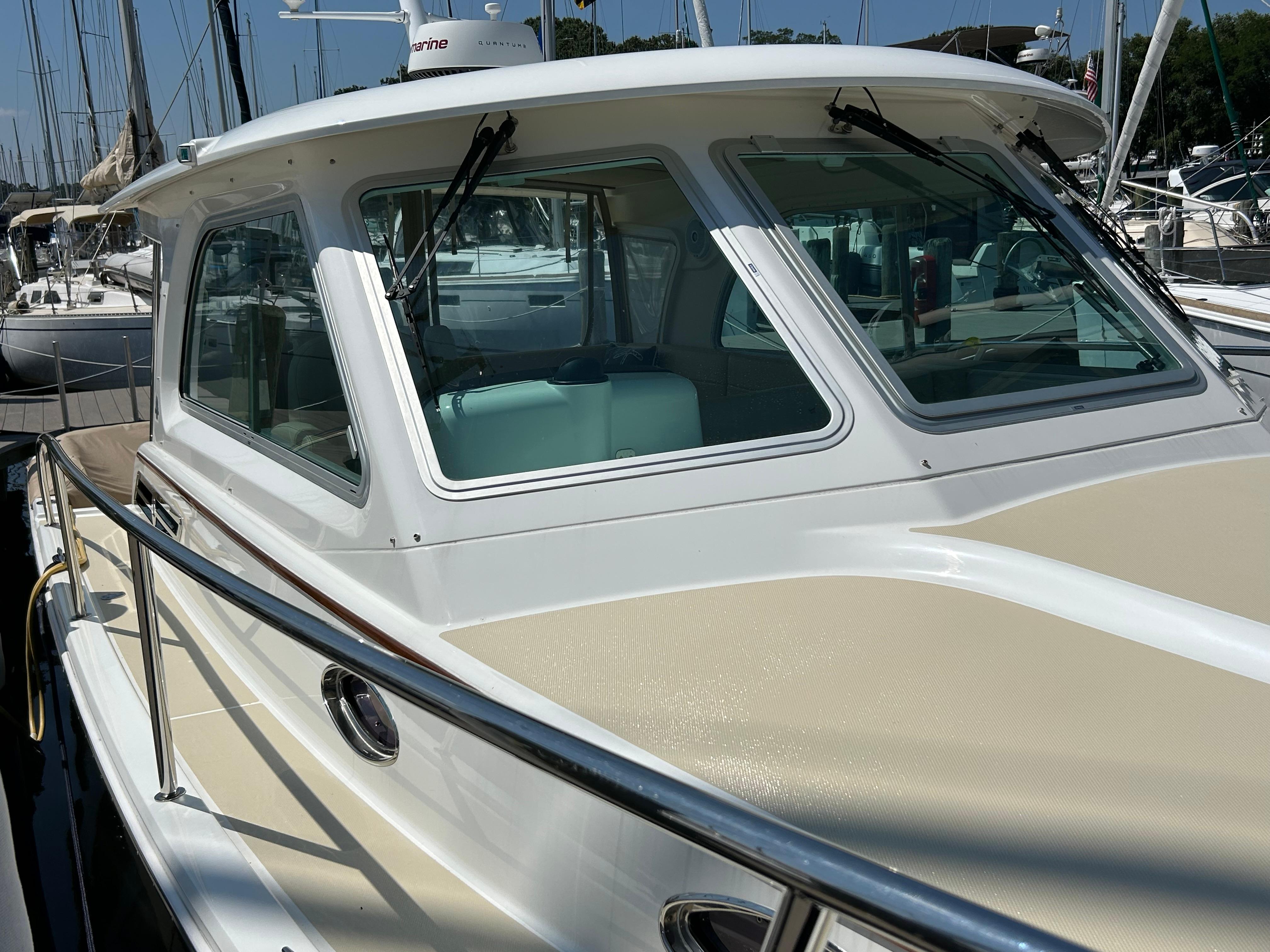 2018 Back Cove 32 boat docked, showcasing sleek design and spacious cabin.