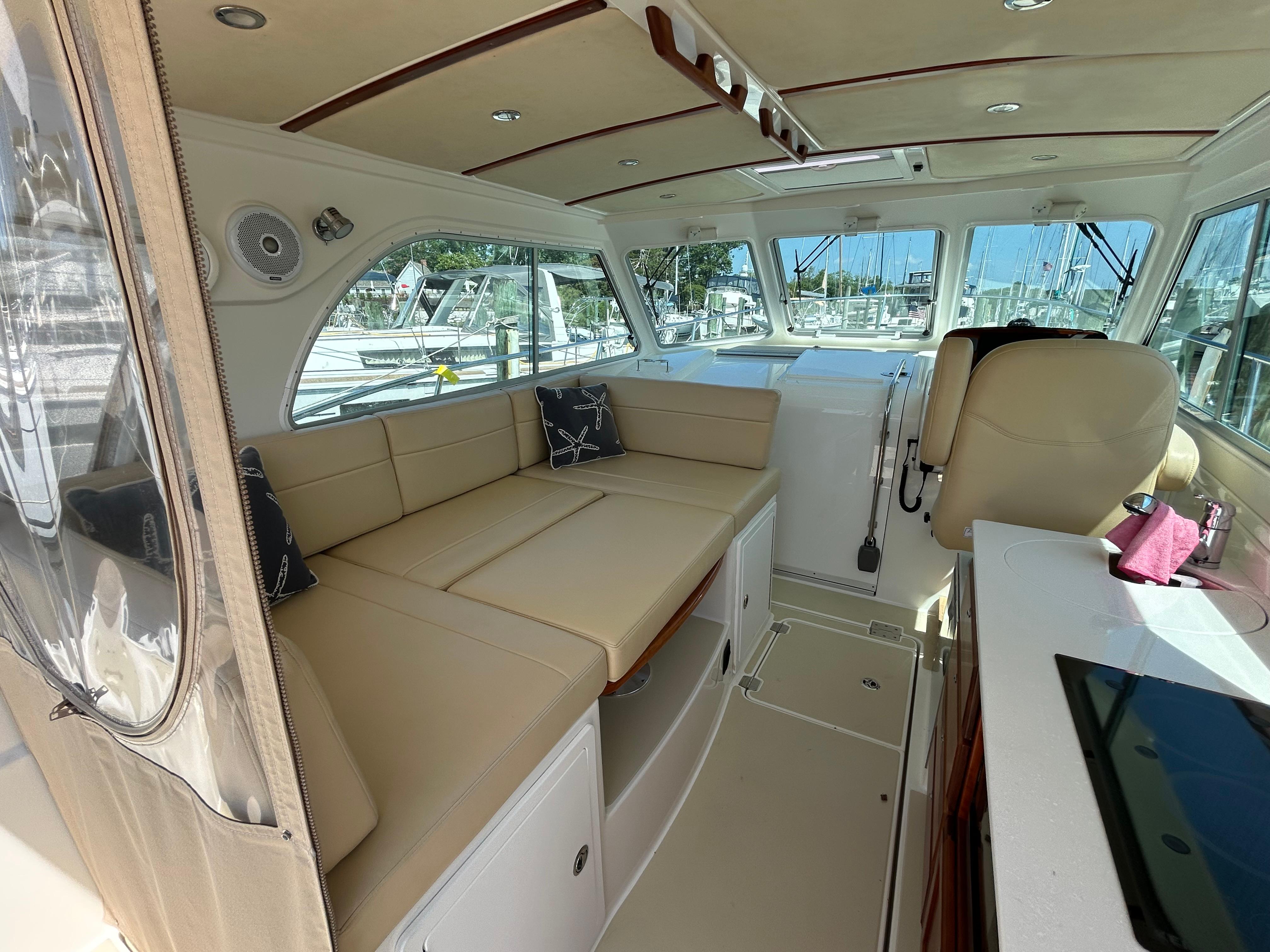 Interior of 2018 Back Cove 32 boat with beige seating and modern amenities.