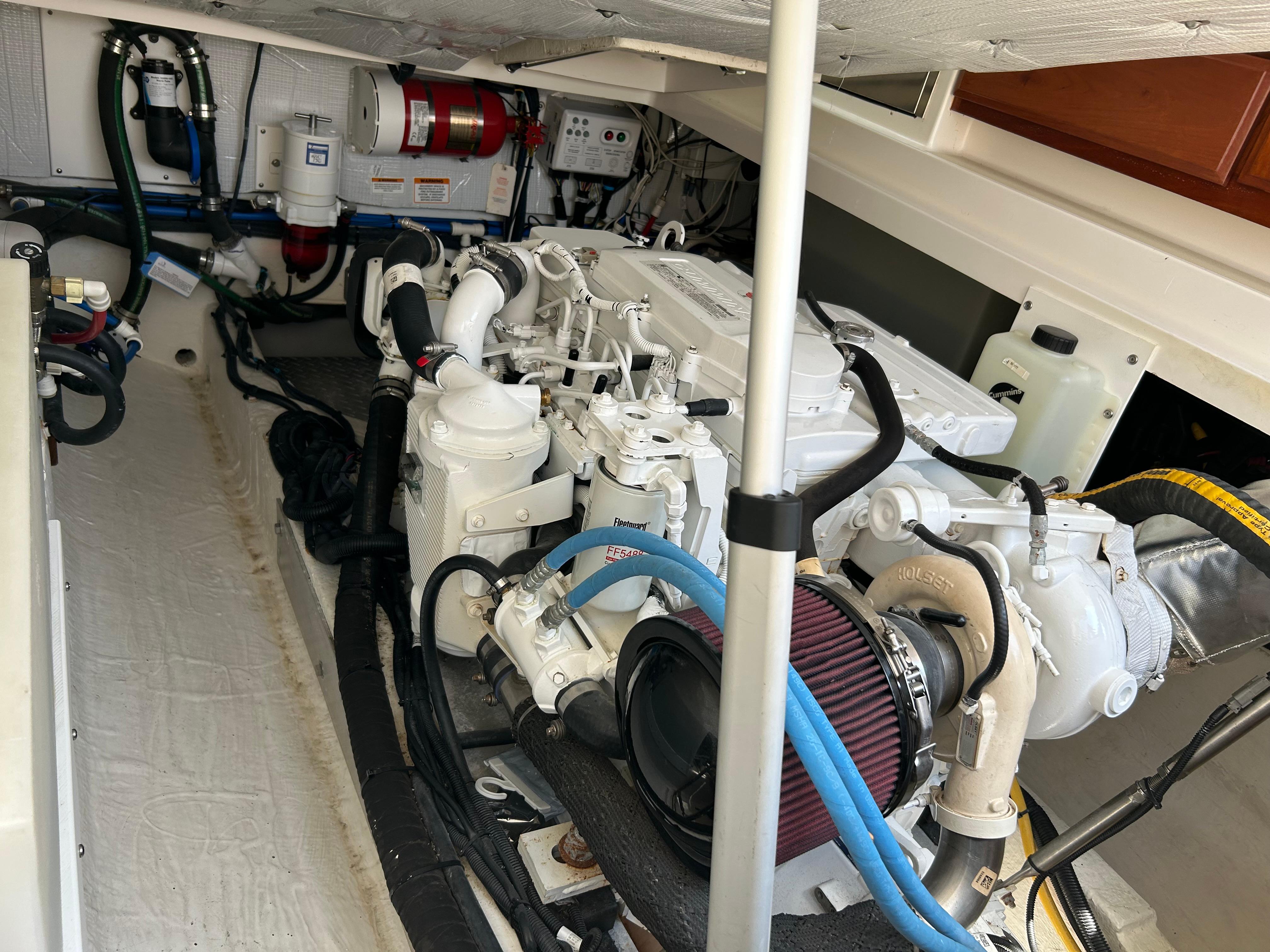 Engine compartment of a 2018 Back Cove 32 boat, showcasing mechanical components and systems.
