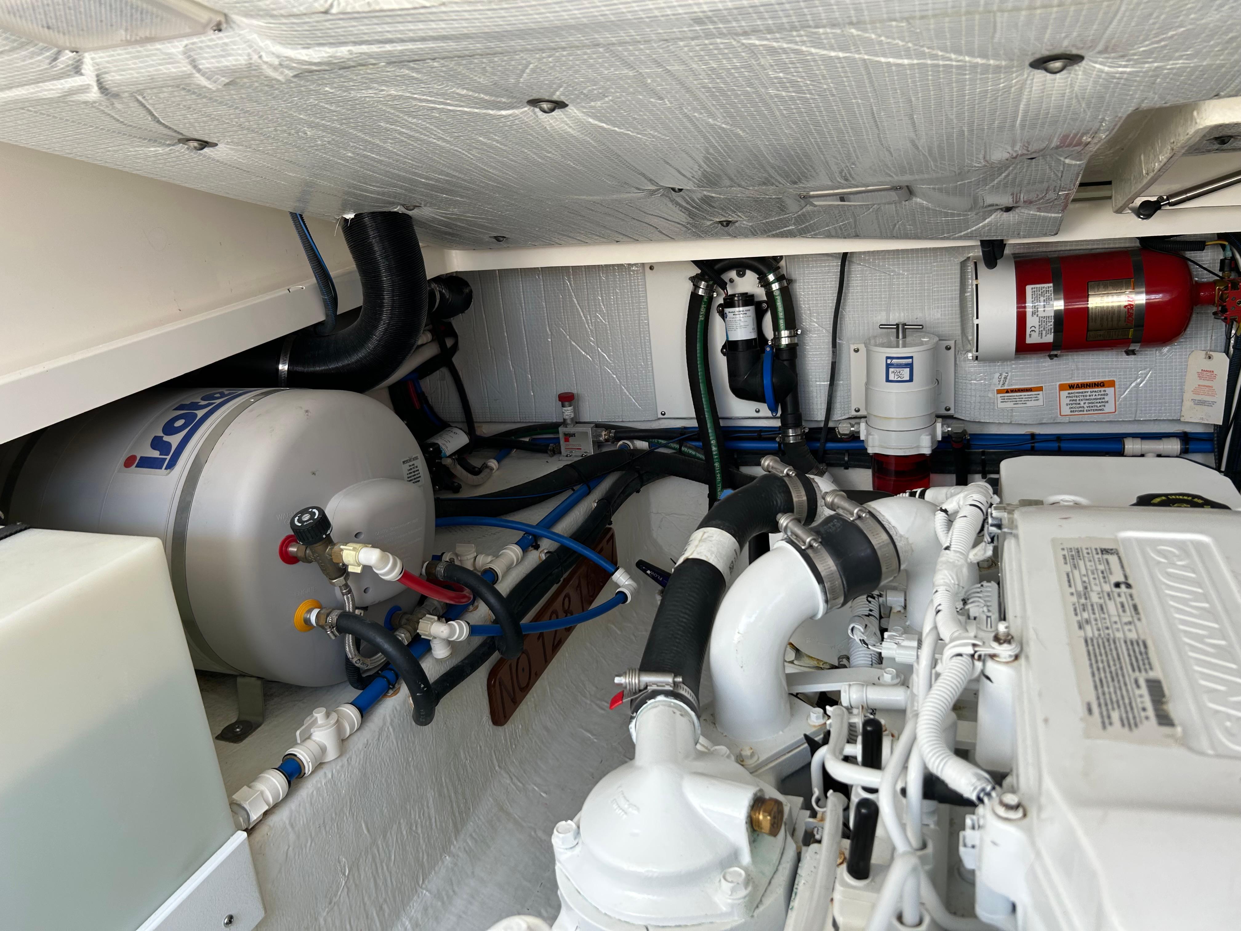 Engine room of 2018 Back Cove 32 boat, featuring Cummins engine and Isotemp water heater.