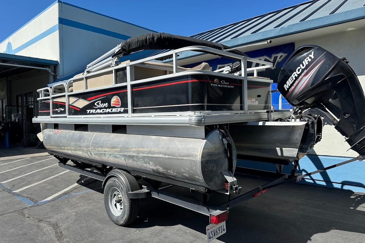 2019 Sun Tracker Bass Buggy 18 DLX pontoon boat with Mercury outboard motor on trailer.