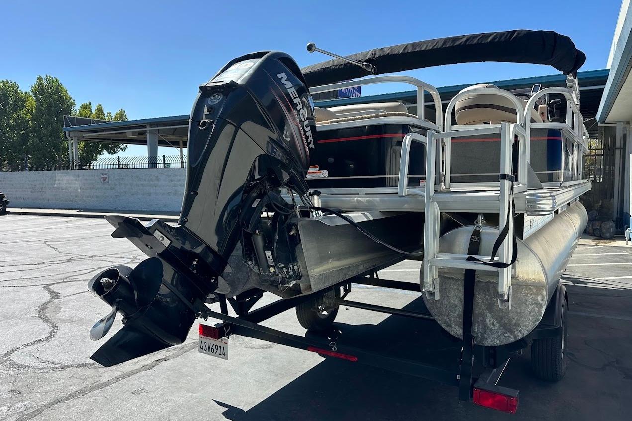 2019 Sun Tracker Bass Buggy 18 DLX pontoon boat with Mercury outboard motor on trailer.