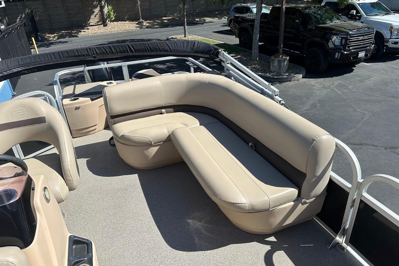 2019 Sun Tracker Bass Buggy 18 DLX pontoon boat with beige seating and spacious deck.
