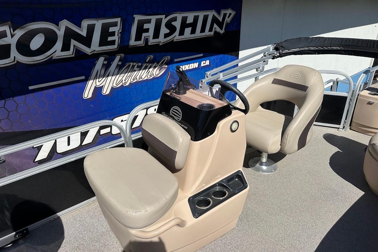 2019 Sun Tracker Bass Buggy 18 DLX boat interior with beige seating and steering console.