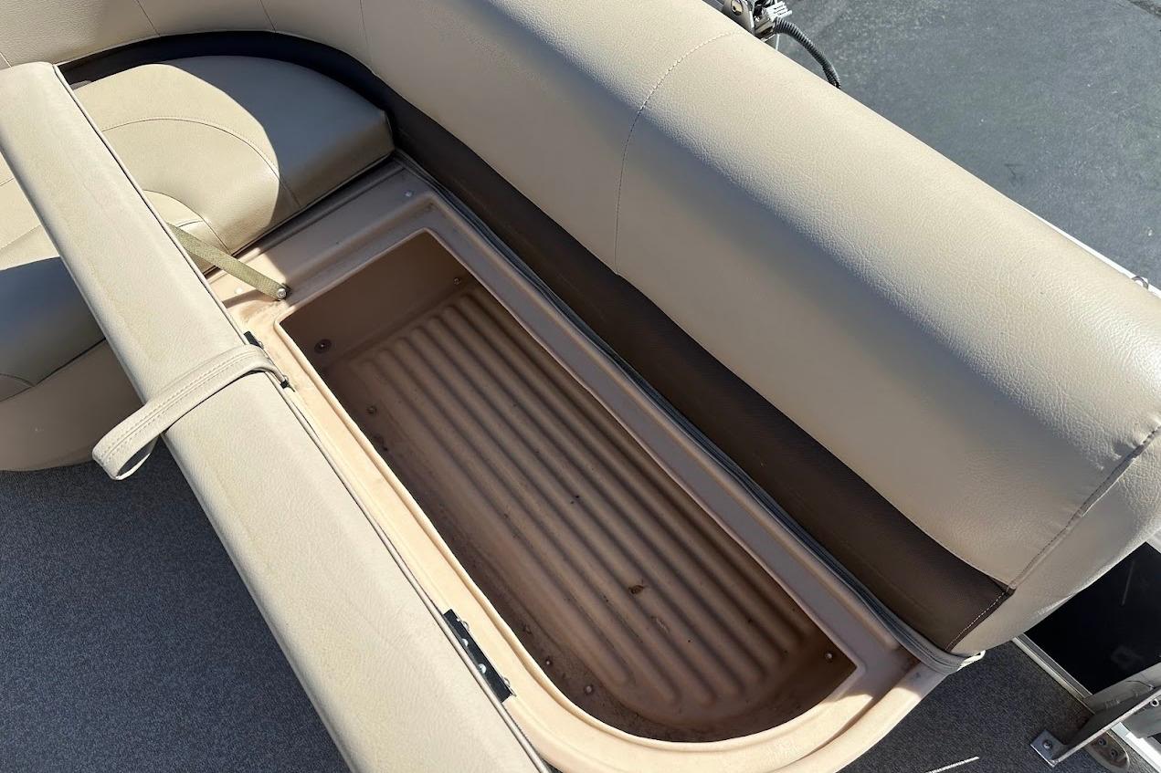 2019 Sun Tracker Bass Buggy 18 DLX boat seat storage compartment, beige upholstery.