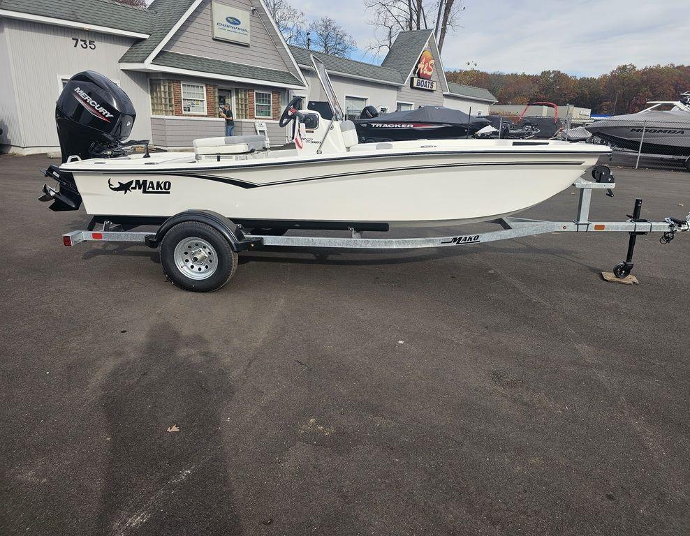 2025 Mako Pro Skiff 15 CC boat on trailer in dealership lot.