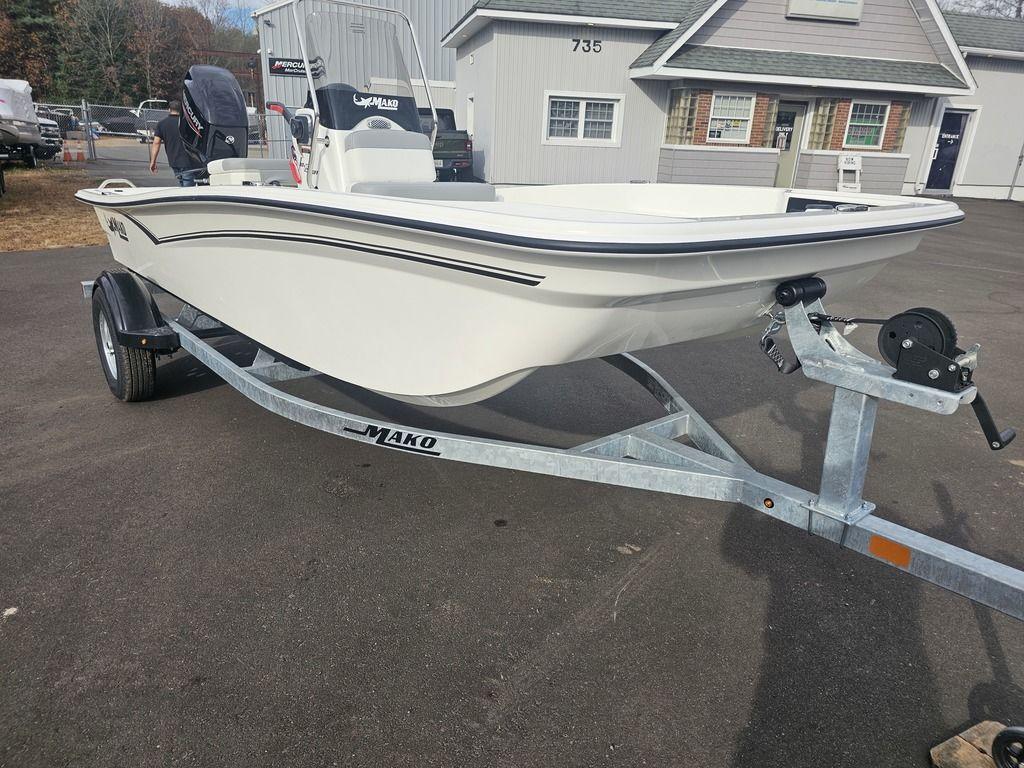 2025 Mako Pro Skiff 15 CC on trailer, parked outside a building.