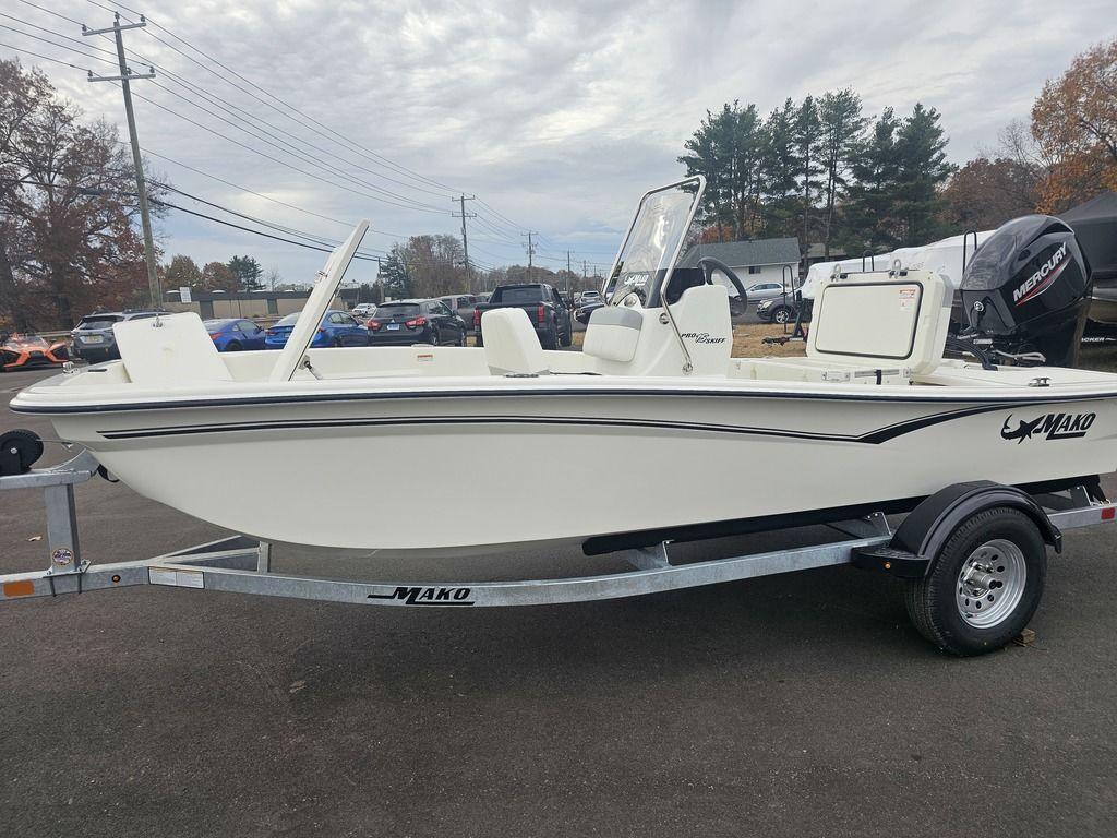 2025 Mako Pro Skiff 15 CC boat on trailer, parked outdoors.