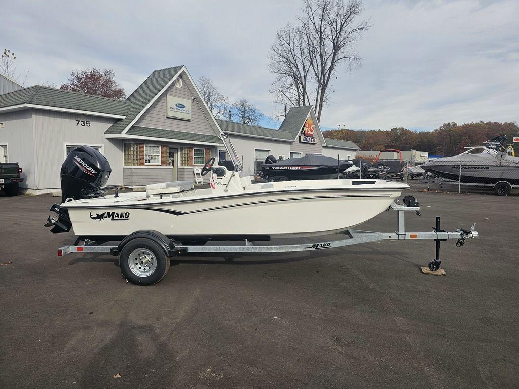 2025 Mako Pro Skiff 15 CC boat on trailer, parked outside dealership.