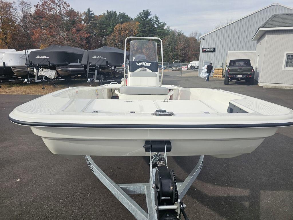 2025 Mako Pro Skiff 15 CC boat on trailer, outdoor dealership setting.