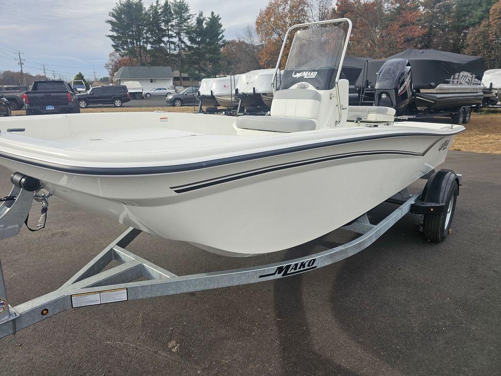 2025 Mako Pro Skiff 15 CC boat on trailer, parked outdoors.