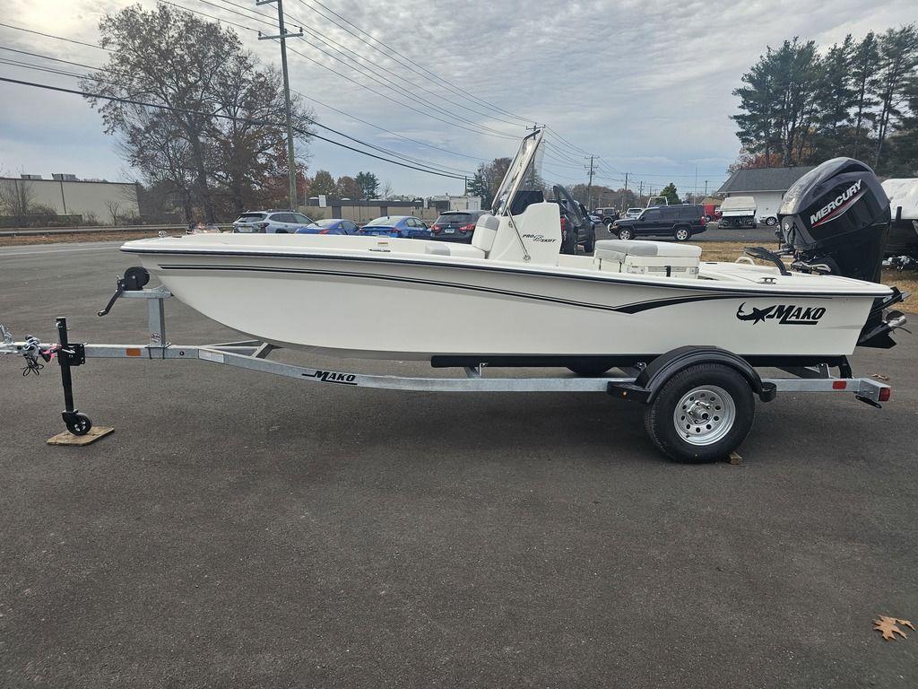 2025 Mako Pro Skiff 15 CC boat on trailer, parked outdoors.