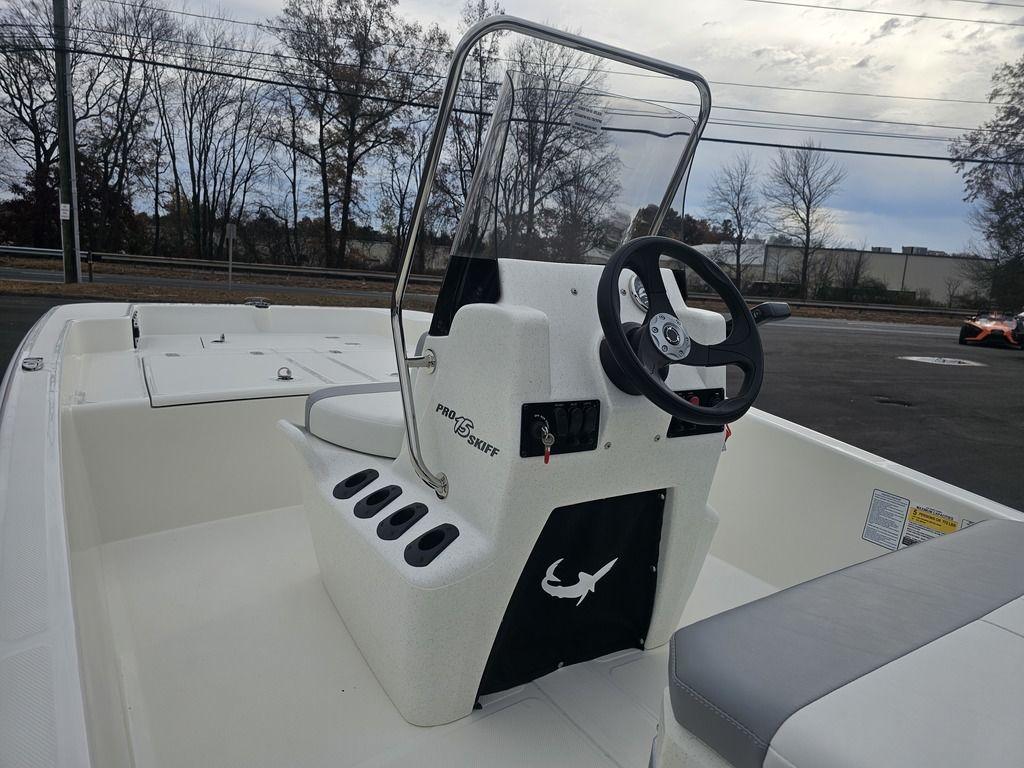 2025 Mako Pro Skiff 15 CC boat interior with steering console and seating.