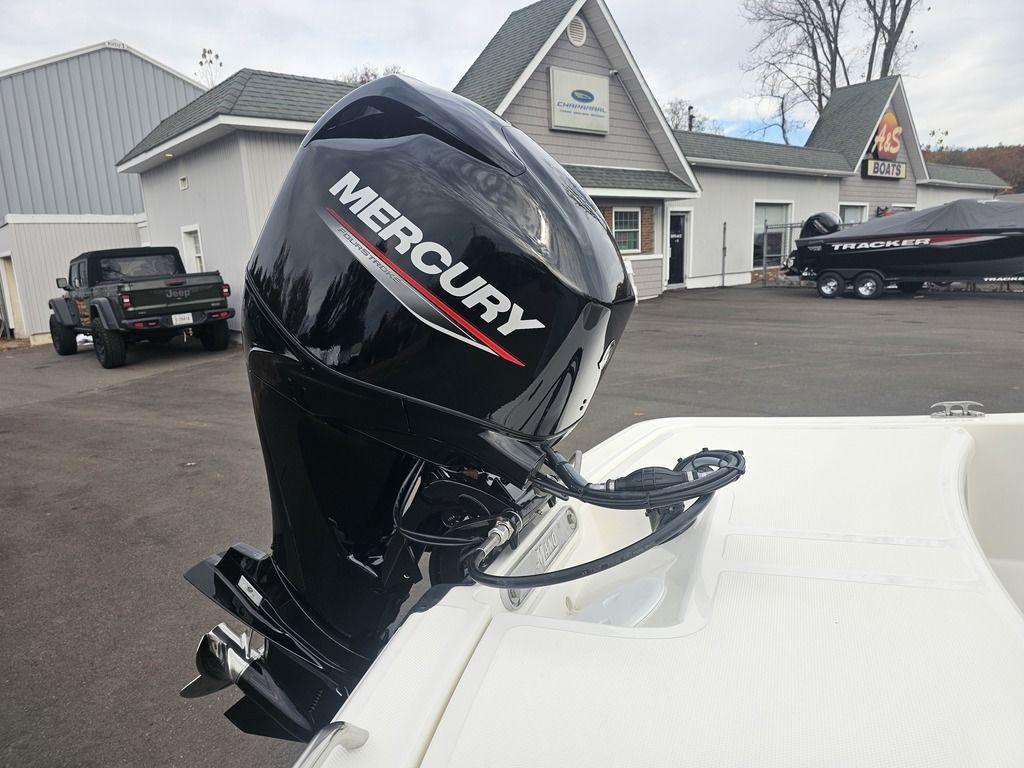 2025 Mako Pro Skiff 15 CC with Mercury outboard motor in a dealership lot.