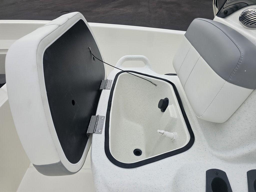 2025 Mako Pro Skiff 15 CC boat storage compartment with open lid and seating.