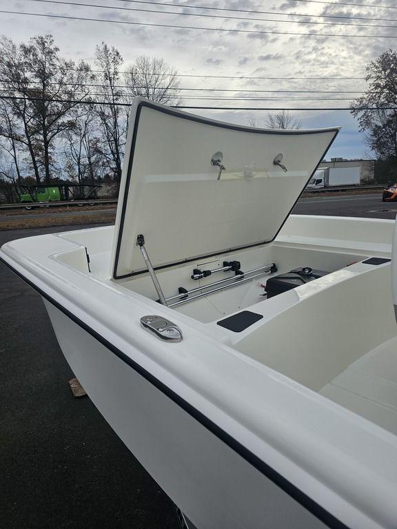 2025 Mako Pro Skiff 15 CC boat with open storage compartment.